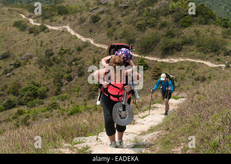 Hikers walking up the steep trails of Sunset Peak, Tai Tung Shan, located on Lantau Island Hong Kong China Stock Photo