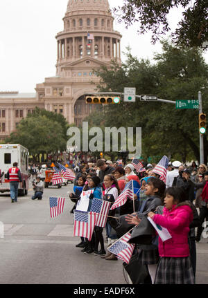 Well wishers line up on sidewalk on Congress Avenue in Austin, Texas to show  support during the annual Veteran's Day parade Stock Photo