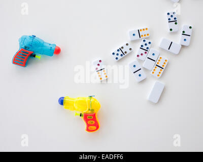 dominoes and water pistols Stock Photo