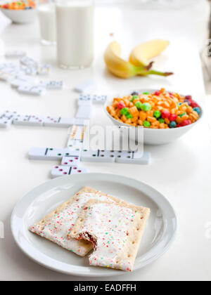 Pop Tarts and breakfast on table with games Stock Photo