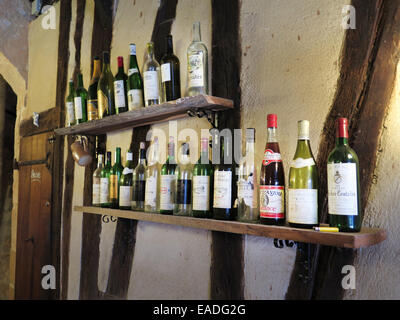 Old wine bottles on a shelf at a restaurant in Bergerac