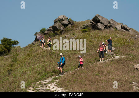 Hikers walking down the steep trails of Sunset Peak, Tai Tung Shan, located on Lantau Island Hong Kong China Stock Photo