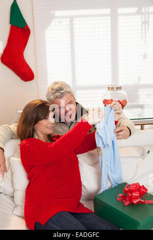 Pregnant opening gift with hes husband Stock Photo
