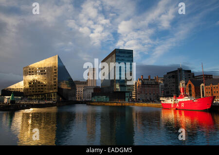 Albert docks in Liverpools dockland;  Canning dock and Mann Island Architectural dockland landmarks in Liverpool, Merseyside, UK 12th November, 2014. UK Weather. After a showery day the low sun illuminates the Pier Head buildings & docks on the seafront waterfront. Stock Photo