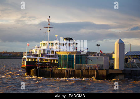 Liverpool, Merseyside, UK 12th November, 2014. UK Weather. Mersey Ferry boat SNOWDROP at the quayside of the Pier Head Ferry Terminal . After a showery day the low sun illuminates the Pier Head buildings on the Waterfront. Stock Photo