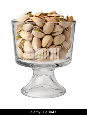 A group of green pistachio nuts, with shells, in a dessert glass. Stock Photo