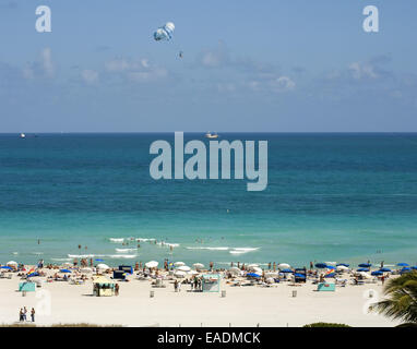 Miami Beach with bathers and parasailer Stock Photo