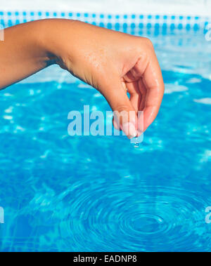 Reading a water thermometer in swimming pool, checking water temperature  Stock Photo - Alamy