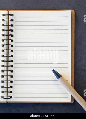 pen and notebook on a black board Stock Photo