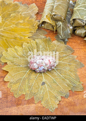 cooking of Caucasus meal - dolma from pickled grape leaves and mince and rice close up Stock Photo