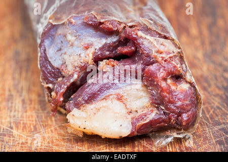 horse meat sausage kazy close up on cutting wooden board Stock Photo