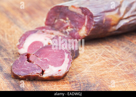 chopped horse meat sausage kazy close up on cutting wooden board Stock Photo