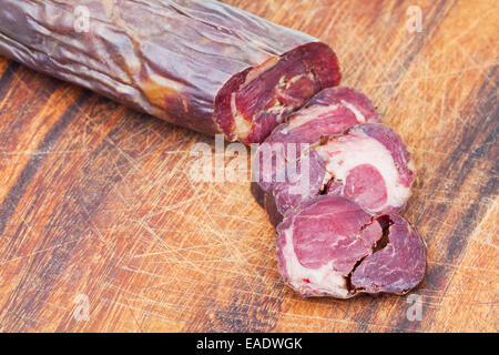 chopped horse meat sausage kazi on cutting wooden board Stock Photo