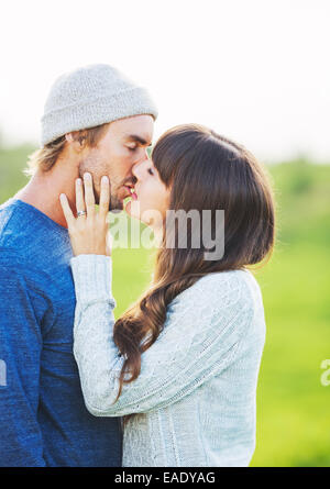 Happy Young Couple Having Fun Outdoors. Romantic Couple Kissing in Love. Stock Photo