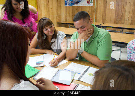 Female students, male teacher in class at Achieve Early College High School in McAllen TX on the campus of South Texas College Stock Photo