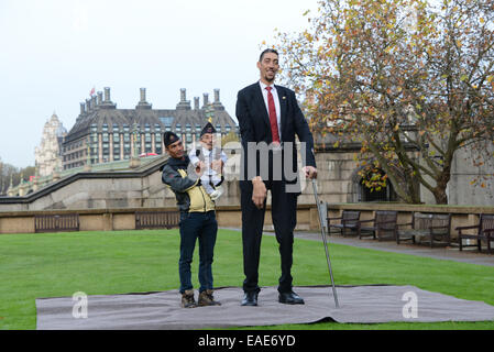 London, UK. 13th November, 2014. Guinness World Records Day 2015 of the World's Tallest Man and the World's Shortest at St Thomas's Hospital in London. The shortest man ever, Chandra Bahadur Dangi (54.6 cm -21.5in) of the World's Tallest Man and the World's Shortest at St Thomas's Hospital in London. The shortest man ever, Chandra Bahadur Dangi (54.6 cm -21.5in) meets the world's tallest man, Sultan Kosen for the very first time (251 cm 8 ft 3 in).  Stock Photo