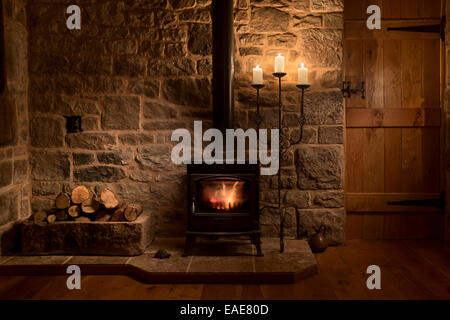 Cosy cottage sitting room with wood burning stove and linen Stock Photo