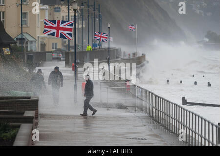 Walkers brave the elements as stormy weather batters the coast in Teignmouth, Devon, UK. Stock Photo