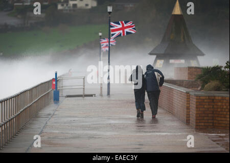 Walkers brave the elements as stormy weather batters the coast in Teignmouth, Devon, UK. Stock Photo