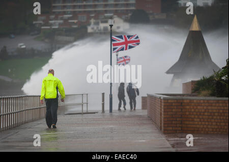 Walkers brave the elements as stormy weather batters the coast in Teignmouth, Devon, UK. Stock Photo