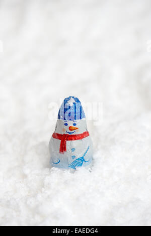 Christmas tree snowman decoration chocolates in snow Stock Photo