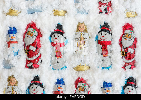 Assorted Christmas tree decoration chocolates in snow Stock Photo