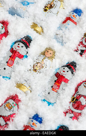 Assorted Christmas tree decoration chocolates in snow Stock Photo