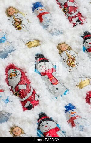 Assorted Christmas tree decoration chocolates in snow Stock Photo