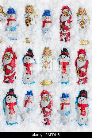 Assorted Christmas tree decoration chocolates in snow Stock Photo