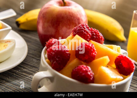 Sliced hard boiled eggs and fruit healthy breakfast