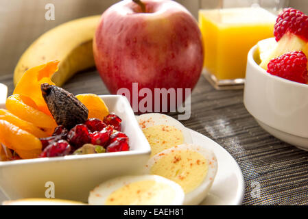Sliced hard boiled eggs and fruit healthy breakfast