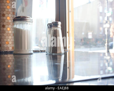 Empty diner table with salt, pepper and sugar shakers. Stock Photo