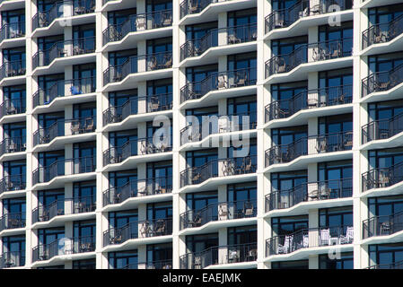 Abstract Architecture: A geometric pattern is created by highlights and shadows of the outdoor patios of a cement building. Stock Photo