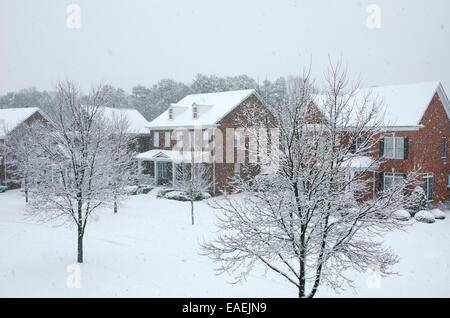 Traditional, brick homes are captured during a snow storm in this beautiful, Winter scene. Stock Photo