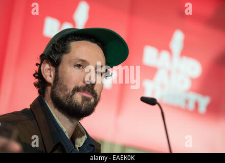 Berlin, Germany. 13th Nov, 2014. Musician Max Herre speaks durign the start of #BandAid30 Germany in Berlin, Germany, 13 November 2014. A Christmas song will be produced with more than 25 German bands with 100 percent of the proceed going to help people infected with Ebola. Credit:  dpa picture alliance/Alamy Live News Stock Photo