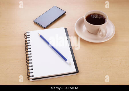 Empty notepad and modern smart phone mockup on white office desk surrounded  with office supplies. Top view. Flat lay Stock Photo - Alamy