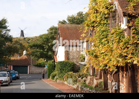 Rottingdean village - its old buildings and windmill, East Sussex. The man in the image happens to have his face covered and is Stock Photo