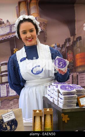 Woman in traditional costume selling Sarah Nelson's Grasmere Gingerbread. Stock Photo