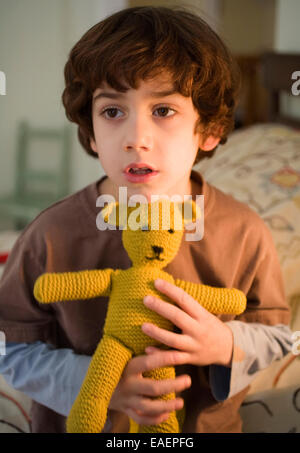 Young boy holding teddy bear Stock Photo