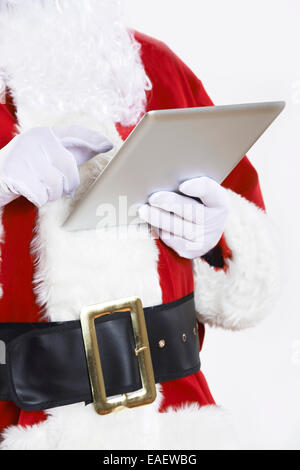 Santa Claus Using Digital Tablet On White Background Stock Photo
