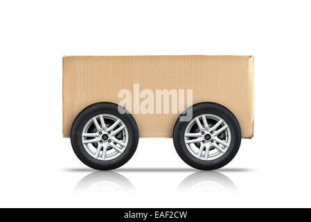 Cardboard box with automotive wheels isolated on white background, self delivery concept metaphor Stock Photo