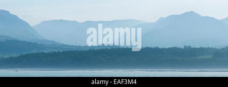 A hazy panoramic view over the Menai Strait towards Bangor and Snowdonia National Park Stock Photo