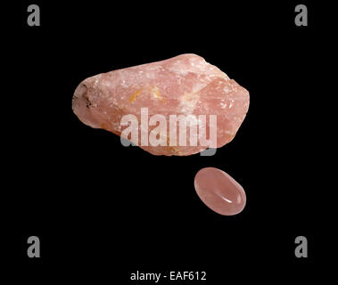 Rose quartz, one raw and the other round and shiny pebble, isolated on black Stock Photo
