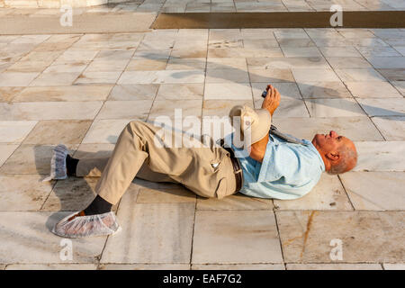 A Tourist Lays On His Back To Take Photos Of The Taj Mahal, Agra, Uttar Pradesh, India Stock Photo