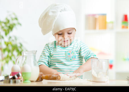 little baker kid girl in chef hat Stock Photo