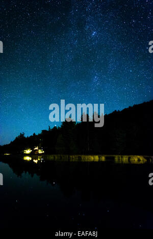 Stars in the night sky reflecting in Echo Lake, at Acadia National Park, Maine. Stock Photo