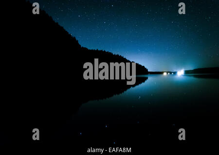 Stars in the night sky reflecting in Echo Lake, at Acadia National Park, Maine. Stock Photo