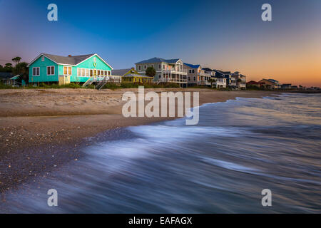 Waves in the Atlantic Ocean and beachfront homes at sunrise, Edisto Beach, South Carolina. Stock Photo