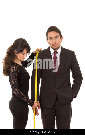 young woman tailor designer taking measures of client Stock Photo