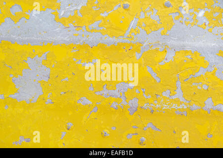 flaking yellow paint on an old aluminum boat background texture Stock Photo